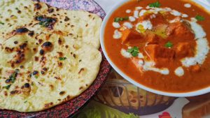 The soft, fluffy naan,Butter Naan with Paneer Curry: A Professional Recipe Guide, brushed with butter, perfectly complements the rich, spiced, and creamy paneer curry. This dish is ideal for festive dinners, family gatherings