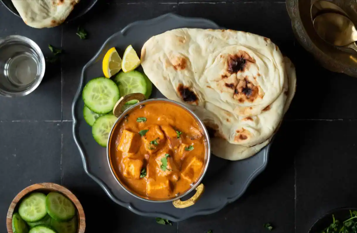 The soft, fluffy naan,Butter Naan with Paneer Curry: A Professional Recipe Guide, brushed with butter, perfectly complements the rich, spiced, and creamy paneer curry. This dish is ideal for festive dinners, family gatherings